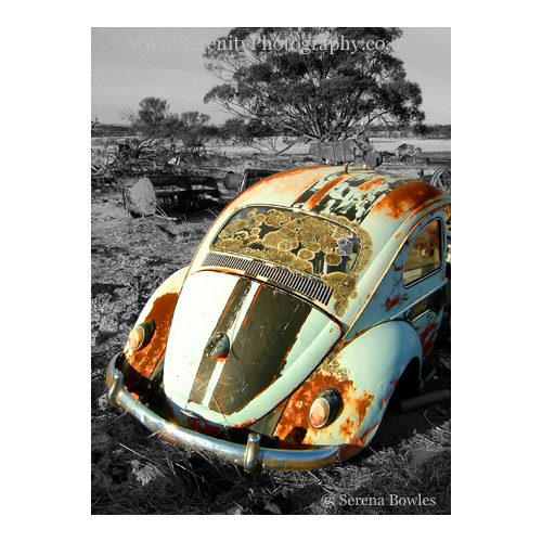 Colour composite of a rusting VW Beetle in a field in Australia.